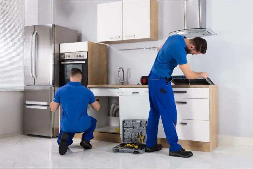 Gavino Plumbing Services technicians working on a kitchen sink and dishwasher installation